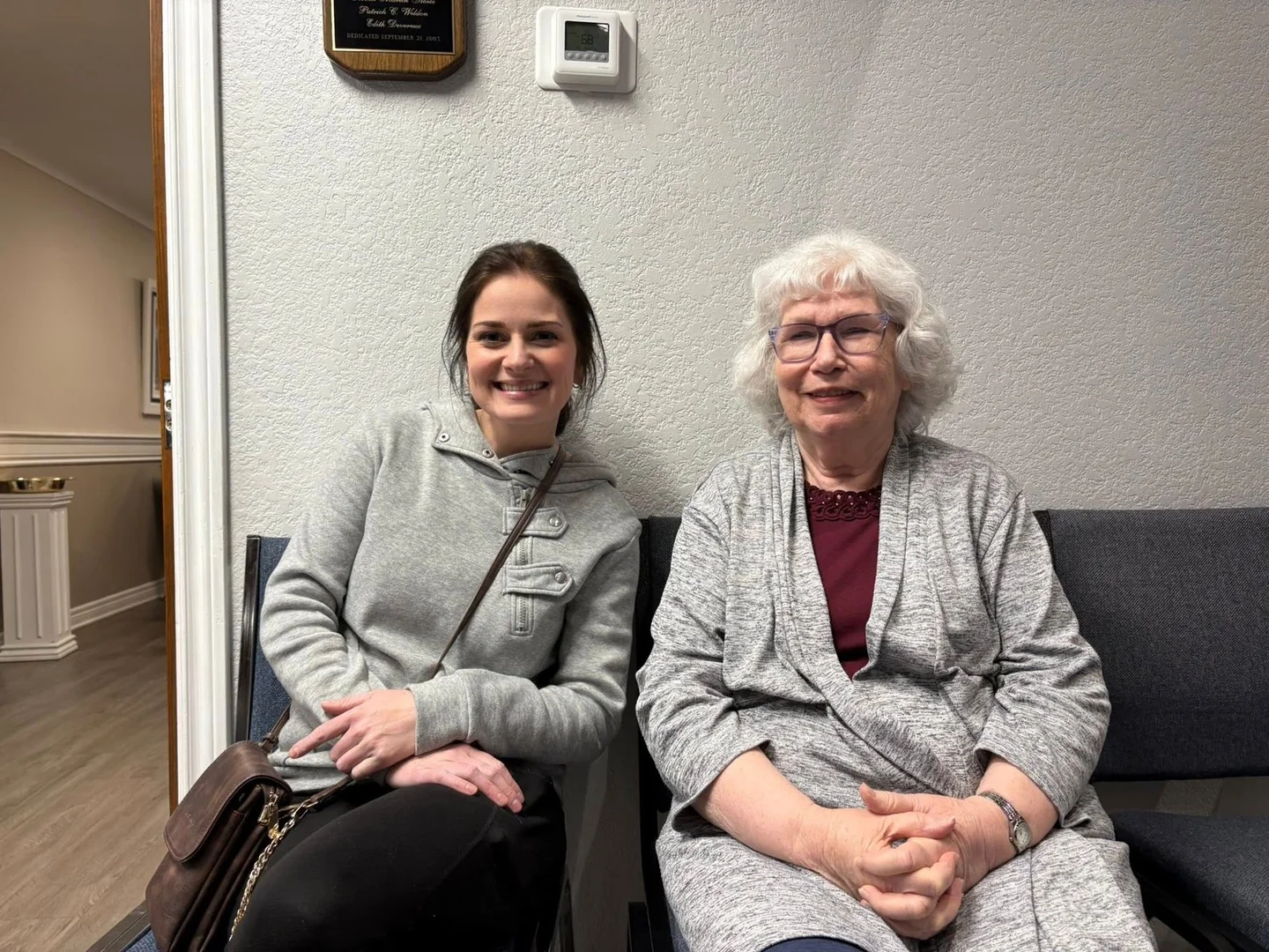 Two women sitting together at church.